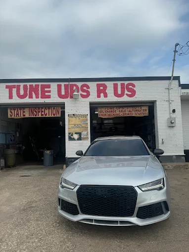 Silver Audi RS7 parked in front of the Tune Ups R Us state inspection bay